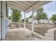 View from covered porch overlooking large backyard with wooden path, sheds, garage, and garden at 233 N 10Th Ave, Brighton, CO 80601