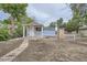 A light blue cottage-like building with white trim and a small porch in the backyard at 233 N 10Th Ave, Brighton, CO 80601