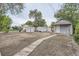 Large backyard features wooden walkway, shed, garage, and potential for landscaping at 233 N 10Th Ave, Brighton, CO 80601