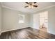 Bedroom with view to the bathroom, hardwood floors, window and light-blue walls at 233 N 10Th Ave, Brighton, CO 80601