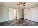 Bedroom featuring hardwood floors, closet, and a doorway to a bathroom at 233 N 10Th Ave, Brighton, CO 80601