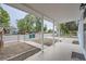 Covered front porch featuring white columns, a concrete floor, and a view of the neighborhood at 233 N 10Th Ave, Brighton, CO 80601