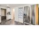 Modern kitchen with stainless steel refrigerator and door to a pantry with a floral curtain at 233 N 10Th Ave, Brighton, CO 80601