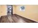 Living room with hardwood floors, yellow walls and access to the kitchen through a sliding barn door at 233 N 10Th Ave, Brighton, CO 80601