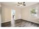 Inviting living room featuring modern ceiling fan, dark wood-look flooring, and natural light at 233 N 10Th Ave, Brighton, CO 80601