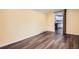 Living room with hardwood floors, yellow walls and access to the kitchen through a sliding barn door at 233 N 10Th Ave, Brighton, CO 80601
