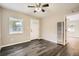 Cozy living room featuring a ceiling fan, a window view, and dark-toned flooring for a modern touch at 233 N 10Th Ave, Brighton, CO 80601