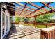 Wood deck featuring a wooden pergola, and access to a manicured backyard and lawn at 4894 E Ashton Ave, Castle Rock, CO 80104