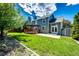 Picture of the fenced in backyard featuring a deck, patio, shed, and lawn at 4894 E Ashton Ave, Castle Rock, CO 80104