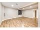 Unfinished basement featuring hardwood floors, and a window at 4894 E Ashton Ave, Castle Rock, CO 80104