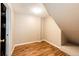 View of the unfinished basement featuring wood-look floors and access to mechanicals at 4894 E Ashton Ave, Castle Rock, CO 80104