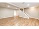 Spacious basement features hardwood floors, recessed lighting and a stairway at 4894 E Ashton Ave, Castle Rock, CO 80104