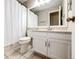 Bathroom with a vanity with cabinets, toilet and a shower curtain covered shower at 4894 E Ashton Ave, Castle Rock, CO 80104