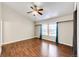 Spacious bedroom featuring hardwood floors, a ceiling fan, and large windows at 4894 E Ashton Ave, Castle Rock, CO 80104