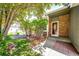 Charming brick front entrance with decorative door and manicured landscaping at 4894 E Ashton Ave, Castle Rock, CO 80104