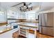 Bright kitchen featuring white cabinets, stainless steel appliances, and a functional center island at 4894 E Ashton Ave, Castle Rock, CO 80104