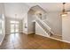 Bright living room featuring tile floors, staircase and ample natural light from the french doors at 4894 E Ashton Ave, Castle Rock, CO 80104