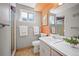 Bathroom with shower, window, and grey walls with a bright orange ceiling accent at 588 Newark St, Aurora, CO 80010