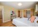 Bedroom with hardwood floors, a comfortable queen bed, closet, and an en-suite bathroom at 588 Newark St, Aurora, CO 80010