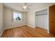 Bedroom with hardwood floors, closet, large window with view to the outside at 588 Newark St, Aurora, CO 80010