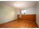 A well-lit bedroom offers classic wood floors, neutral walls, and a charming window with a view at 588 Newark St, Aurora, CO 80010