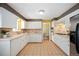Well-lit kitchen featuring tiled countertops, matching backsplash, and white cabinetry at 588 Newark St, Aurora, CO 80010