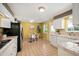 Functional kitchen with tile floors, white appliances, and an adjacent dining area with natural light at 588 Newark St, Aurora, CO 80010