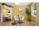 Bright kitchen nook with a table, tiled floors, and abundant natural light from a large window at 588 Newark St, Aurora, CO 80010