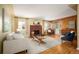 Bright living room featuring a brick fireplace, hardwood floors, and natural light at 588 Newark St, Aurora, CO 80010