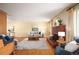 Spacious living room with hardwood floors, brick fireplace, and bright natural light at 588 Newark St, Aurora, CO 80010