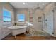 Bright bathroom featuring free standing tub, walk-in shower and large windows at 43016 London Dr, Parker, CO 80138