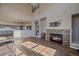 Living room featuring a fireplace with stone surround and wood floors at 43016 London Dr, Parker, CO 80138