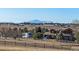 View of fenced property and home with parked car and camper with mountains visible on the horizon on a clear day at 43016 London Dr, Parker, CO 80138