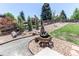 Beautifully landscaped backyard featuring a charming water feature and gravel pathways at 25338 E Costilla Pl, Aurora, CO 80016