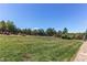 Large, well-maintained backyard featuring lush green grass and a charming fence at 25338 E Costilla Pl, Aurora, CO 80016