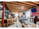 Unfinished basement featuring exposed wood ceiling, a recreational ping pong table, and flexible open space at 25338 E Costilla Pl, Aurora, CO 80016