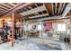 Spacious unfinished basement with exposed ceiling, and ample open area for various activities and storage at 25338 E Costilla Pl, Aurora, CO 80016