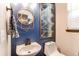Chic powder room with a stylish mirror, modern fixtures, and a serene blue color scheme at 25338 E Costilla Pl, Aurora, CO 80016
