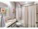 A neutral bathroom with a shower-tub combo, vanity with a sink, modern faucet, and an ornate mirror at 25338 E Costilla Pl, Aurora, CO 80016