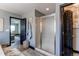 Bathroom area with a shower and toilet visible, decorated with modern lighting fixtures and towel rack at 25338 E Costilla Pl, Aurora, CO 80016