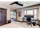 Bedroom with sleek black accents, an expansive desk area, and a comfortable bed, perfect for relaxation and productivity at 25338 E Costilla Pl, Aurora, CO 80016