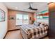 Bedroom with a ceiling fan, window, and a comfortable bed, creating a relaxing and peaceful atmosphere at 25338 E Costilla Pl, Aurora, CO 80016