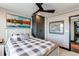 Bedroom with a ceiling fan, a large window with blind, and a comfortable bed, creating a serene and restful environment at 25338 E Costilla Pl, Aurora, CO 80016
