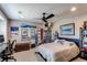 Bedroom with a ceiling fan, wooden chest, and decor creating a comfortable and personalized space at 25338 E Costilla Pl, Aurora, CO 80016