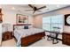 Bedroom featuring a ceiling fan, window, and a cozy rocking chair, creating a comfortable and inviting space at 25338 E Costilla Pl, Aurora, CO 80016