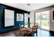Cozy dining area featuring a glass table, modern light fixture, and natural light at 25338 E Costilla Pl, Aurora, CO 80016
