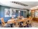 Elegant dining room with a long table, designer chandelier, and an eye-catching modern art piece at 25338 E Costilla Pl, Aurora, CO 80016