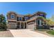 Beautiful two-story home featuring a three-car garage and a combination of siding and stone veneer at 25338 E Costilla Pl, Aurora, CO 80016