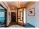 Bright foyer with a modern front door, decorative lighting, and stylish decor at 25338 E Costilla Pl, Aurora, CO 80016