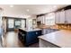 Spacious kitchen with a large island, stainless steel appliances, and an adjacent dining area at 25338 E Costilla Pl, Aurora, CO 80016